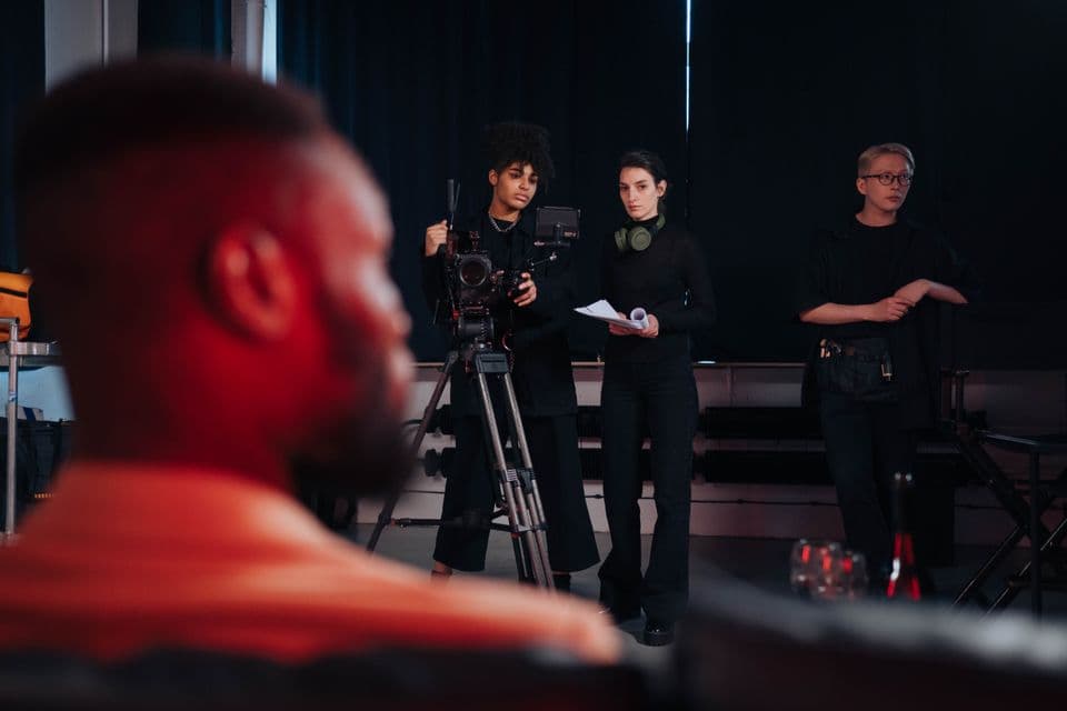 A film crew behind a cinema camera on set